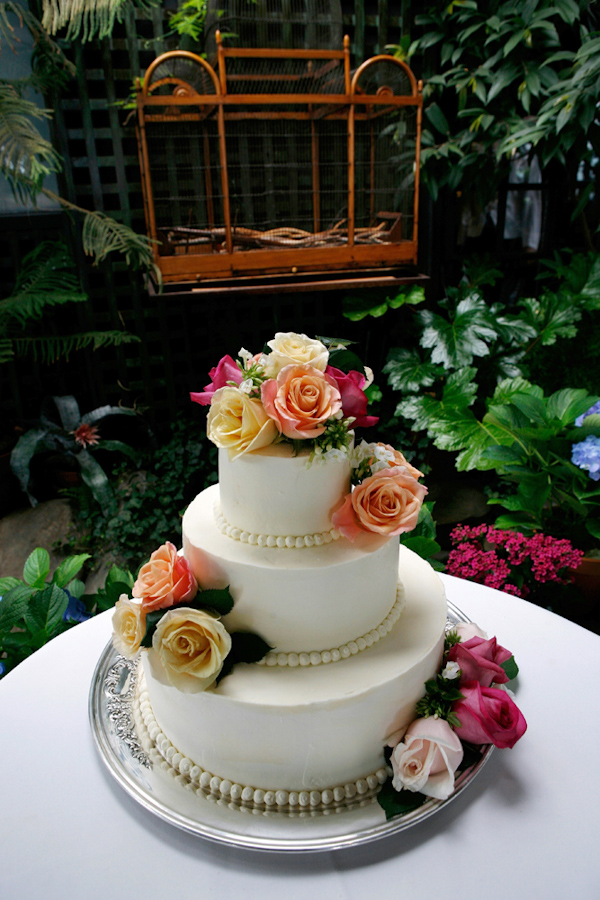 photo by New York based wedding photographer Merri Cry - three tier wedding cake -ivory with yellow, pink, and peach colored roses